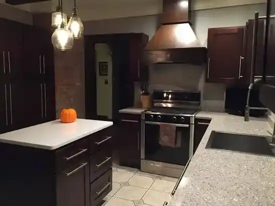 Kitchen renovation done by Noor al Qusais in Dubai with Wooden Brown Cabinets and White Tiles Flooring